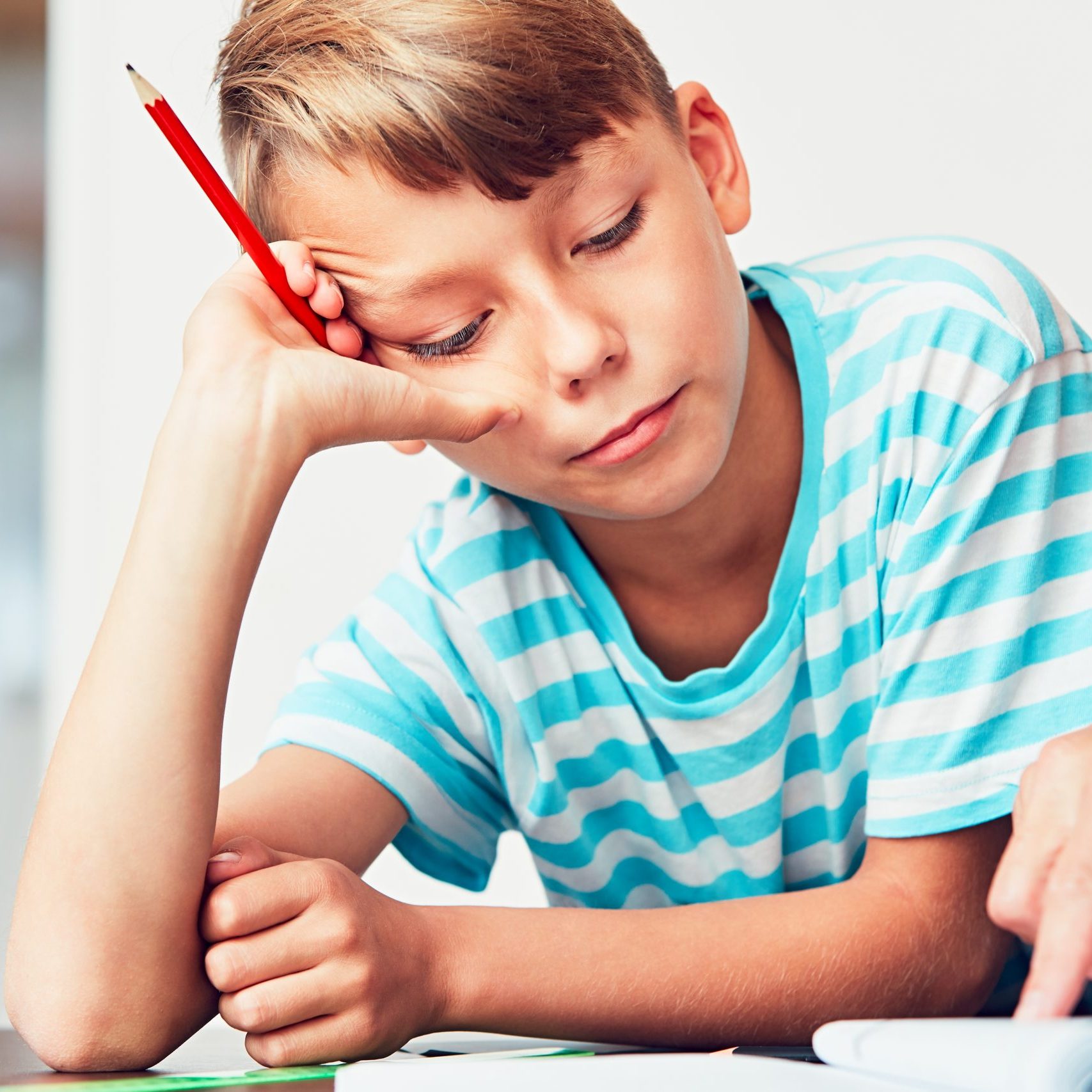 Little boy writing his homework for elementary school.